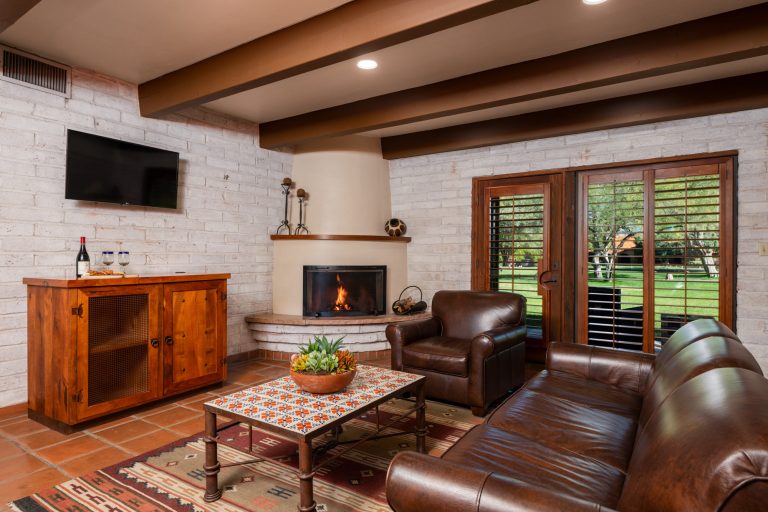 Casita living room with leather couches and a kiva fireplace